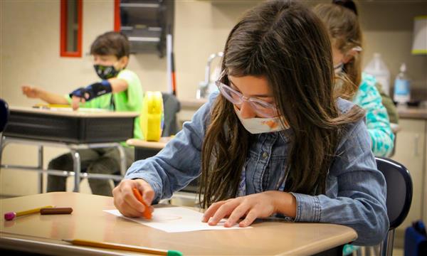 Girl draws on paper